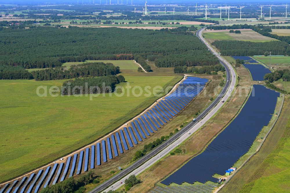 Aerial image Maulbeerwalde - Photovoltaic system and solar power plant - rows of panels on the edge of the lanes of the motorway route and route of the BAB A 24 in Maulbeerwalde in the state Brandenburg, Germany