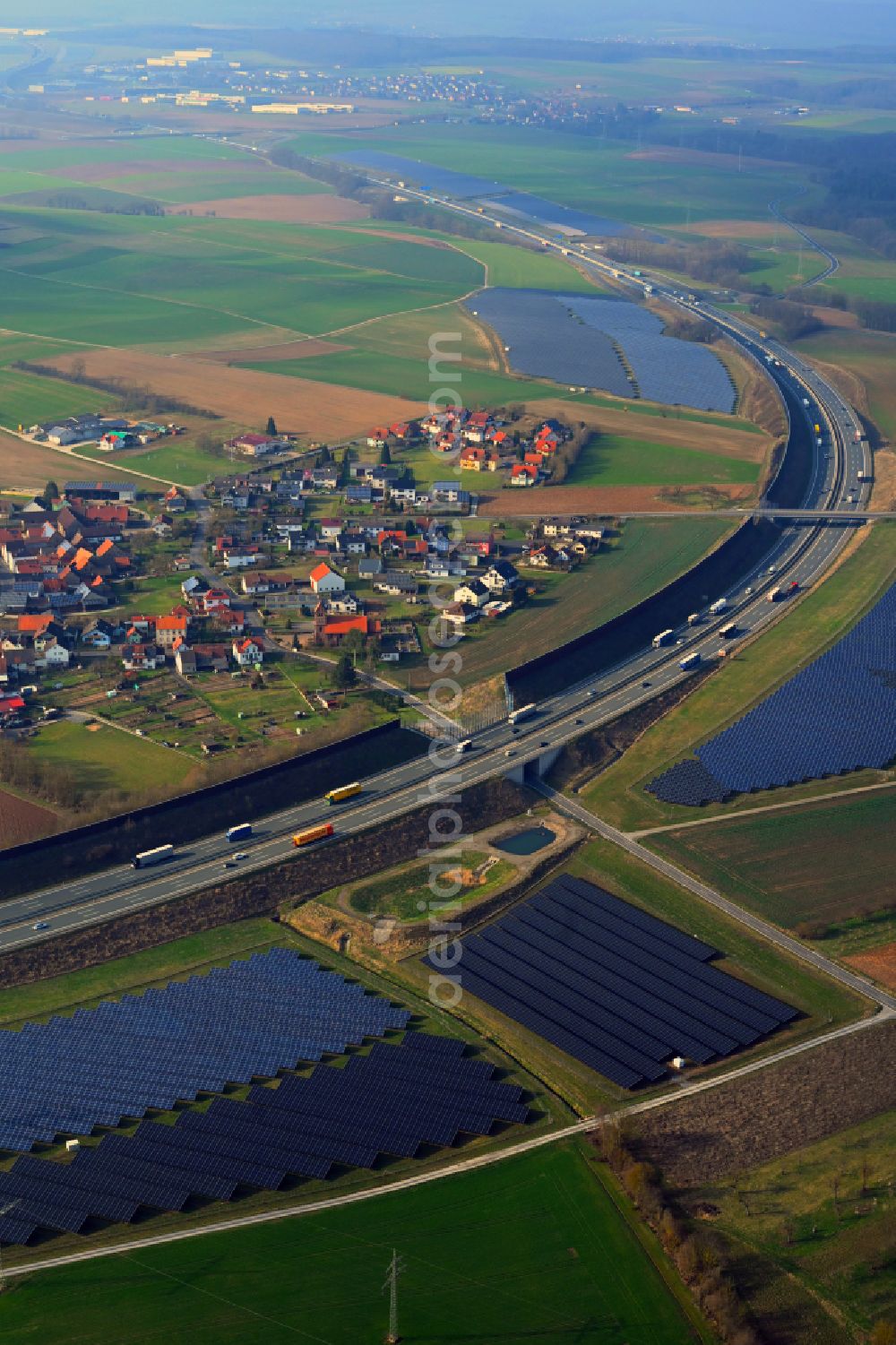 Aerial image Triefenstein - Photovoltaic system and solar power plant - rows of panels on the edge of the lanes of the motorway route and route of the BAB A 3 in Triefenstein in the state Bavaria, Germany