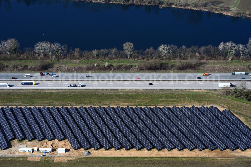 Aerial image Untergrombach - Photovoltaic system and solar power plant - rows of panels on the edge of the lanes of the motorway route and route of the BAB A in Untergrombach in the state Baden-Wuerttemberg, Germany