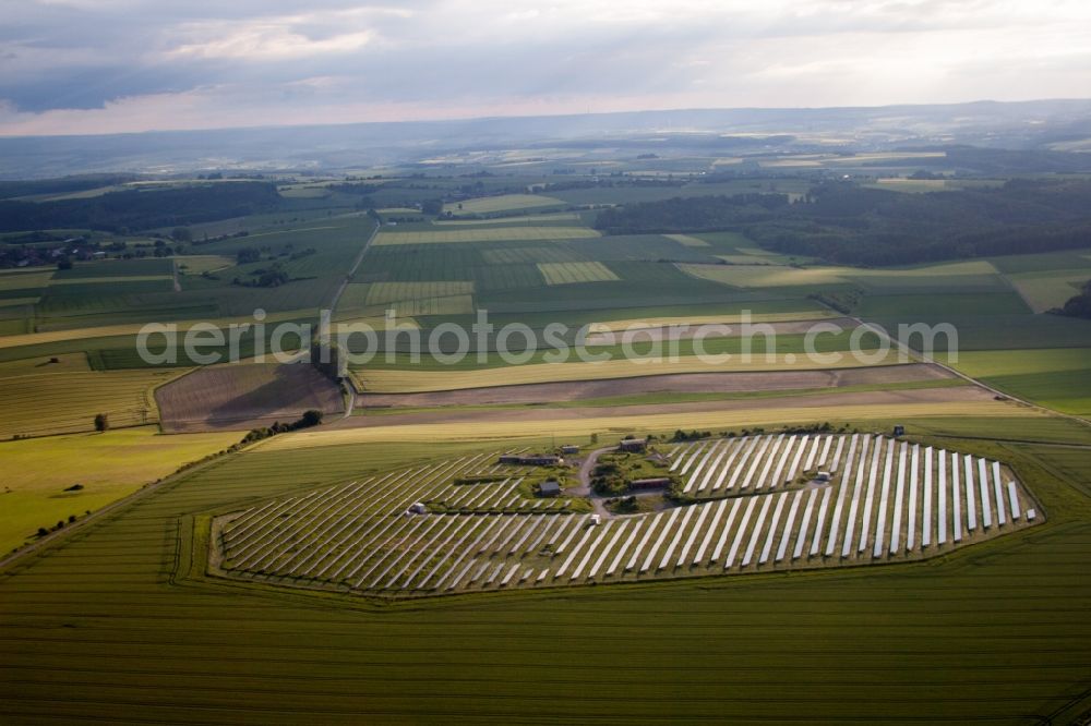 Beverungen from the bird's eye view: Panel rows of photovoltaic and solar farm or solar power plant in Beverungen in the state North Rhine-Westphalia