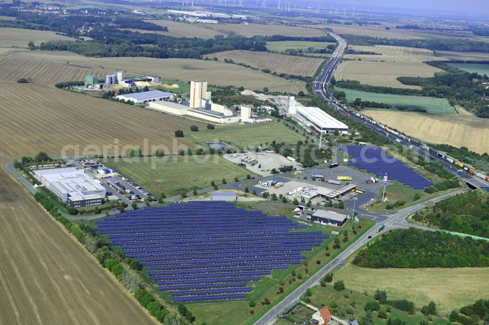 Aerial image Kleinhelmsdorf - Panel rows of photovoltaic and solar farm or solar power plant along the Eisenberger Strasse - Lindenstrasse in Kleinhelmsdorf in the state Saxony-Anhalt, Germany