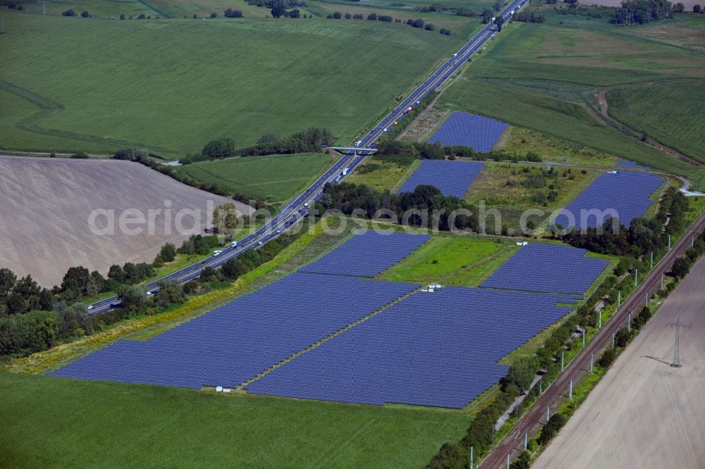 Potsdam from the bird's eye view: Panel rows of photovoltaic and solar farm or solar power plant along the A10 on Bahnhofstrasse - Am Friedrichspark in the district Satzkorn in Potsdam in the state Brandenburg, Germany