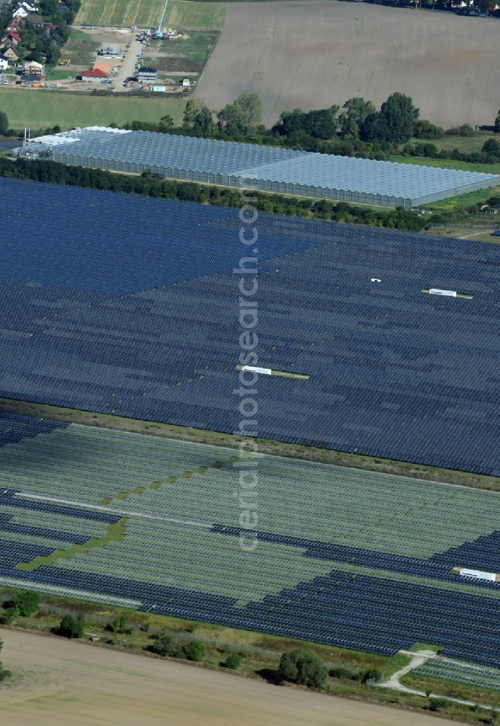 Eiche from above - Panel rows of photovoltaic and solar farm or solar power plant on fields in Eiche in the state Brandenburg, Germany