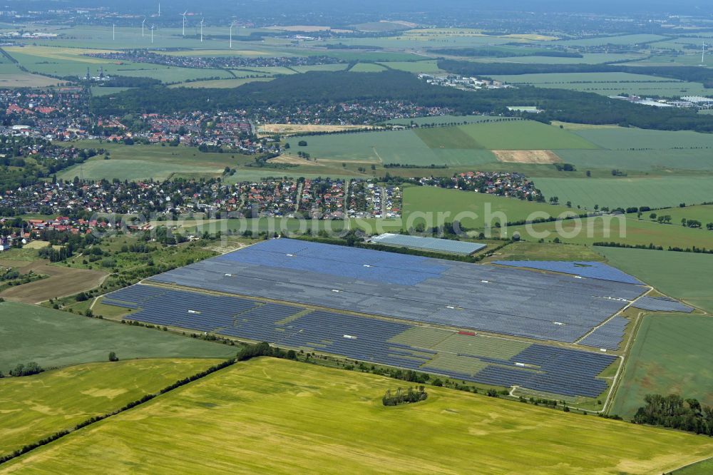 Aerial image Eiche - Panel rows of photovoltaic and solar farm or solar power plant on fields in Eiche in the state Brandenburg, Germany