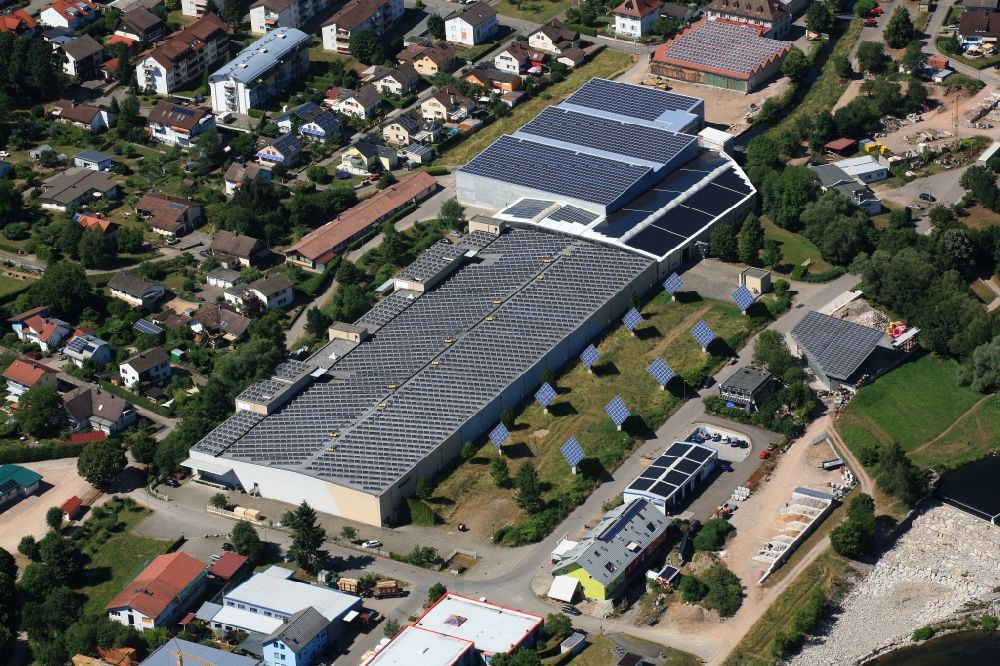 Aerial image Hausen im Wiesental - Panel rows of photovoltaic and solar farm or solar power plant on the company's roof and roof areas of the former textile company Brennet AG in Hausen im Wiesental in the state Baden-Wuerttemberg