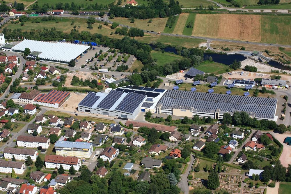 Aerial photograph Hausen im Wiesental - Panel rows of photovoltaic and solar farm or solar power plant on the company's roof and roof areas of the former textile company Brennet AG in Hausen im Wiesental in the state Baden-Wuerttemberg