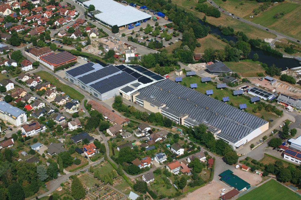 Hausen im Wiesental from above - Panel rows of photovoltaic and solar farm or solar power plant on the company's roof and roof areas of the former textile company Brennet AG in Hausen im Wiesental in the state Baden-Wurttemberg