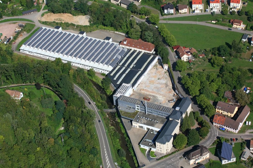 Wehr from above - Panel rows of photovoltaic and solar farm or solar power plant on the company's roof and roof areas of the former textile company Brennet AG in Wehr (Baden) in the state Baden-Wurttemberg