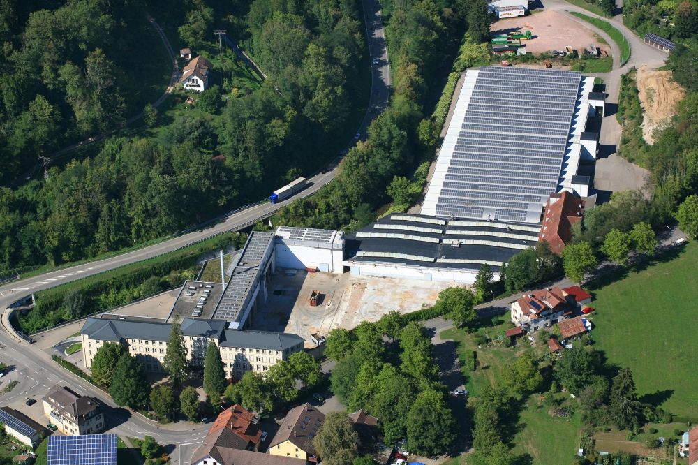 Wehr from the bird's eye view: Panel rows of photovoltaic and solar farm or solar power plant on the company's roof and roof areas of the former textile company Brennet AG in Wehr (Baden) in the state Baden-Wurttemberg