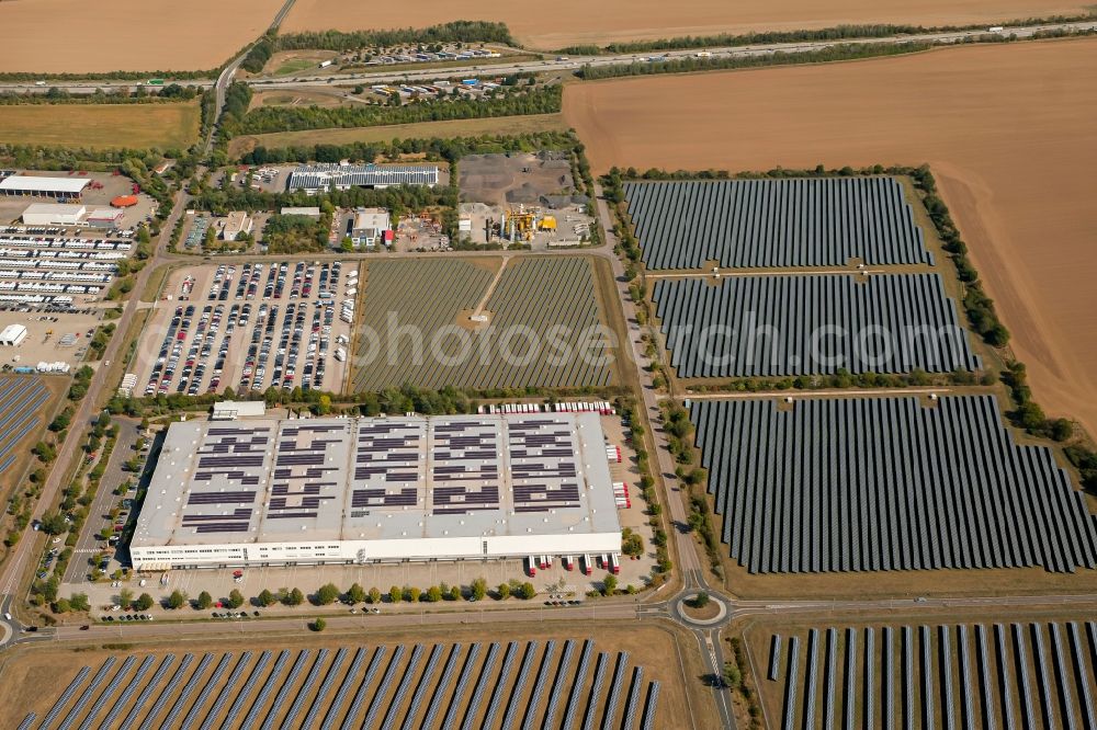 Landsberg from the bird's eye view: Panel rows of photovoltaic and solar farm or solar power plant in the commercial area in the district Sietzsch in Landsberg in the state Saxony-Anhalt, Germany