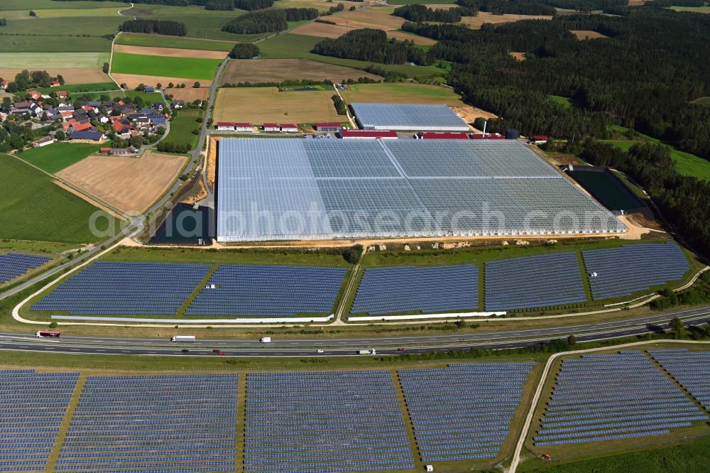 Wonsees from the bird's eye view: Panel rows of photovoltaic and solar farm or solar power plant Jura-Solarpark on BAB A70 in Wonsees in the state Bavaria, Germany