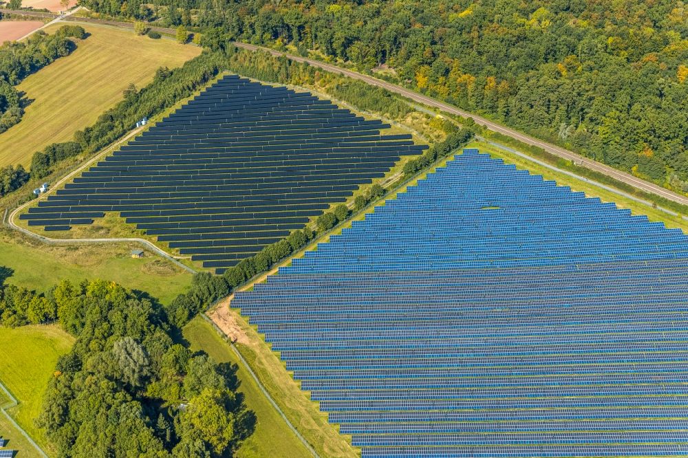 Aerial photograph Bad Driburg - Panel rows of photovoltaic and solar farm or solar power plant on Satzer Moor on Industriestrasse in the district Herste in Bad Driburg in the state North Rhine-Westphalia, Germany