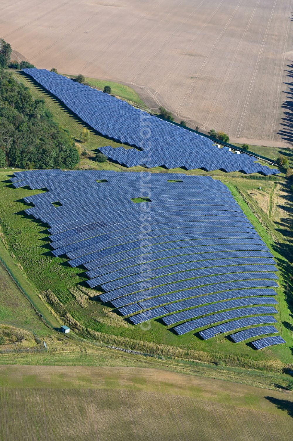 Werneuchen from the bird's eye view: Panel rows of photovoltaic and solar farm or solar power plant in Werneuchen in the state Brandenburg, Germany