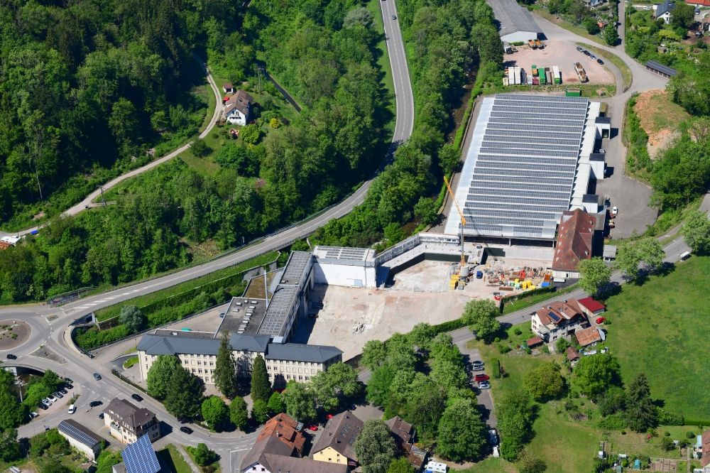 Aerial photograph Wehr - Panel rows of photovoltaic and solar farm on the company's roof of the former textile company Brennet AG in Wehr (Baden) in the state Baden-Wurttemberg. Part of the area is prepared for new residential buildings