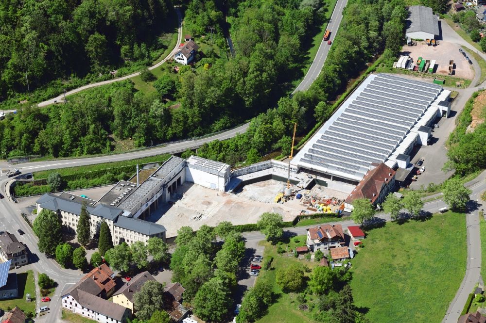 Wehr from above - Panel rows of photovoltaic and solar farm on the company's roof of the former textile company Brennet AG in Wehr (Baden) in the state Baden-Wurttemberg. Part of the area is prepared for new residential buildings