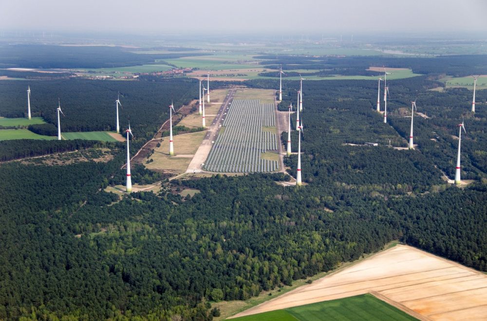 Aerial image Mahlwinkel - Solar park and wind turbines in the Mahlwinkel part of the borough of Angern in the state of Saxony-Anhalt. A large number of solar cells and several wind turbines are located and constructed on site of the former military airbase