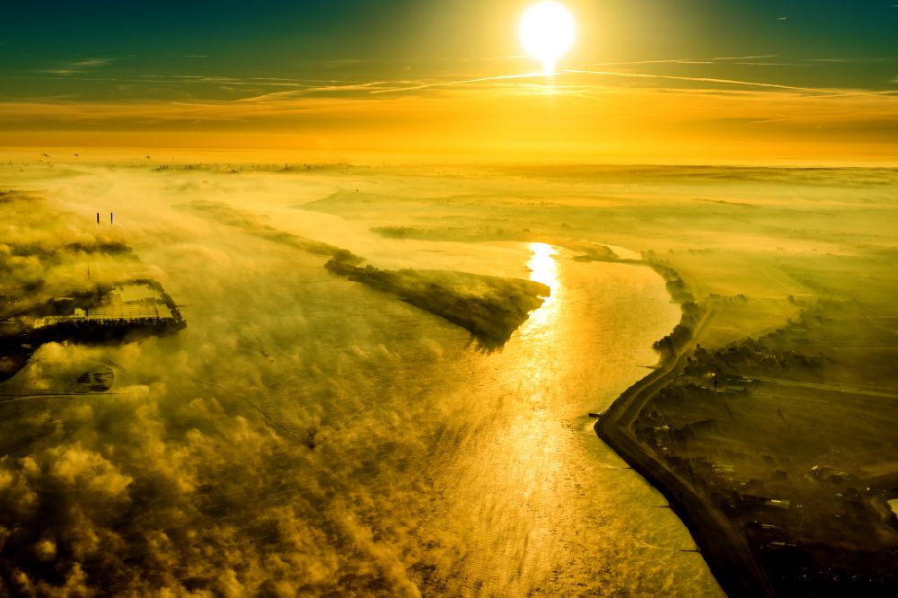 Jork from the bird's eye view: Sunrise over the landscape of the mist covered Elbe island along the Elbe river in the district Wedel in Hamburg, Germany