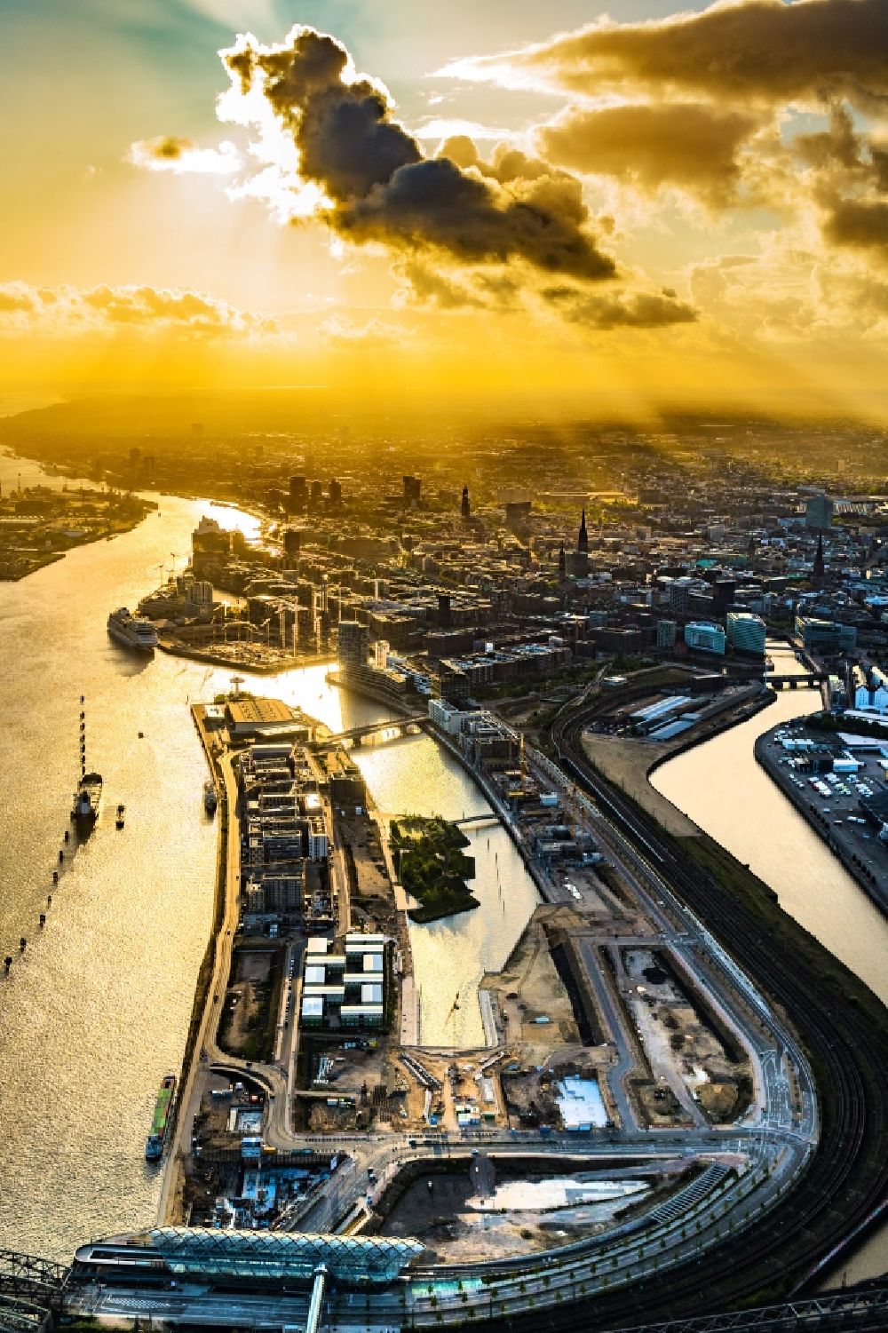 Hamburg from the bird's eye view: Sunset over the construction sites for residential and commercial buildings in the Baakenhafen along the Baakenallee in the district HafenCity in Hamburg, Germany