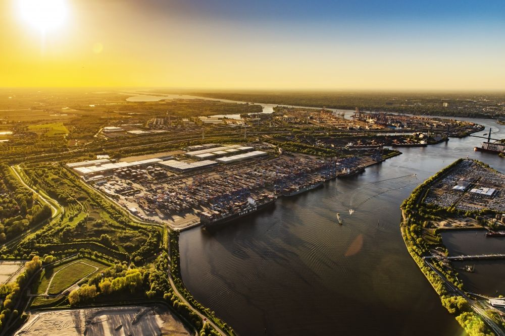 Hamburg from above - Sunset over the landscape of harbor facilities along in Altenwerder district in Hamburg, Germany