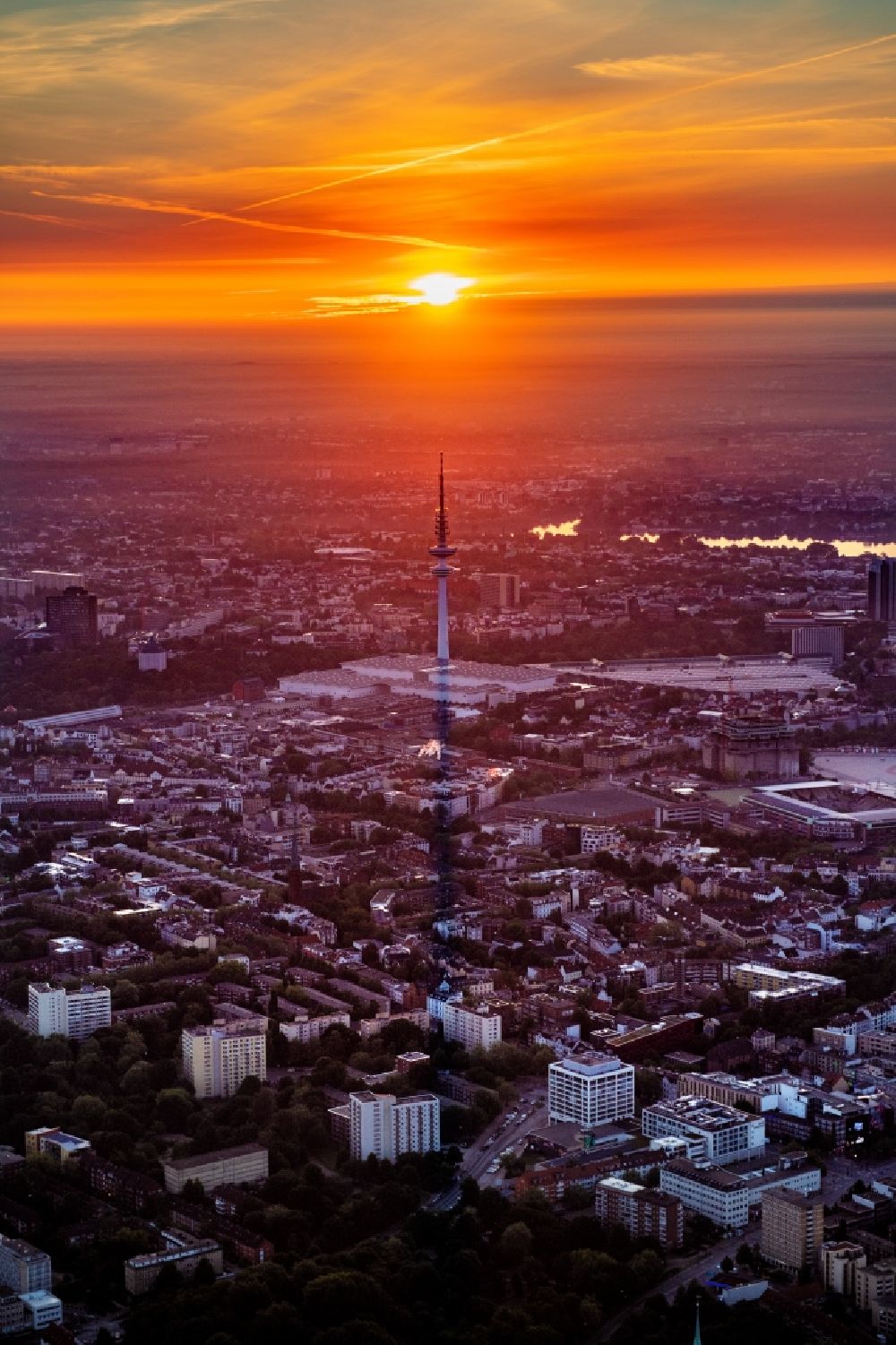 Hamburg from the bird's eye view: Sunrise TV tower Heinrich-Hertz-Turm at the exhibition center in Hamburg. The structure used as a telecommunications tower and for broadcasting stations belongs to the Deutsche Funkturm GmbH