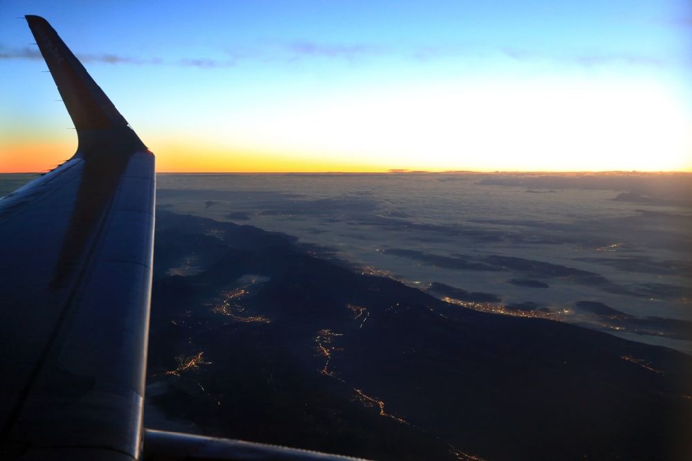 Aerial photograph Biel - Sunrise, seen from an airliner over the mountains of the Swiss Jura in the canton Bern, Switzerland