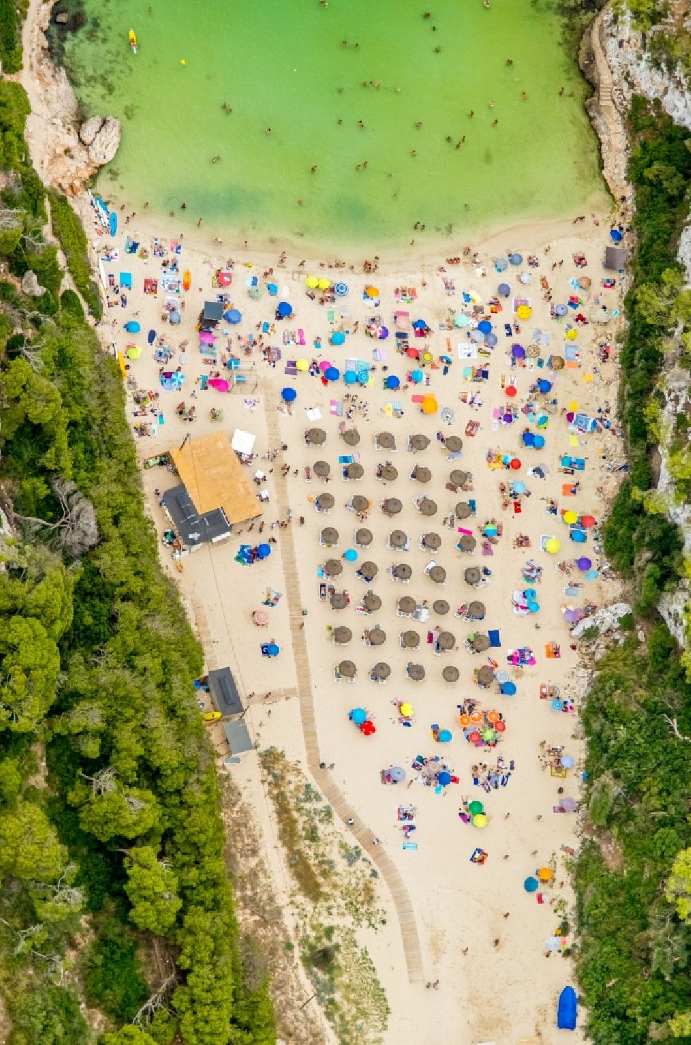 Cala Llombards from above - Row of parasol on the sandy beach ranks in the coastal area Cala Llombards in Cala Llombards in Islas Baleares, Spain