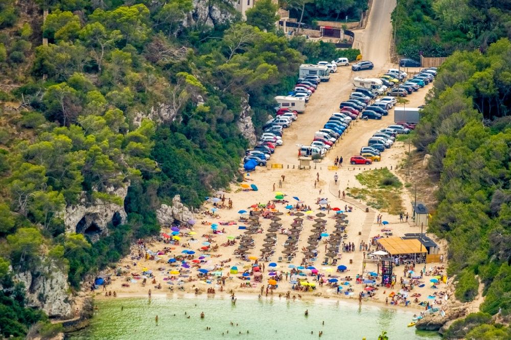 Cala Llombards from the bird's eye view: Row of parasol on the sandy beach ranks in the coastal area Cala Llombards in Cala Llombards in Islas Baleares, Spain