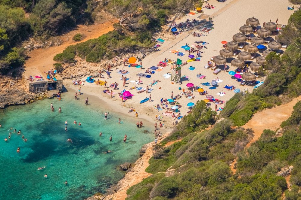 Cala D'or from above - Parasol - rows on the sandy beach in the coastal area of Cala Ferrera in Cala D'or in Balearic island of Mallorca, Spain