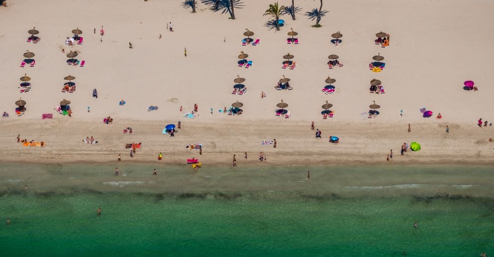 Alcudia from above - Parasol - rows on the sandy beach in the coastal area on Carrer de Saturn in Alcudia in Balearic island of Mallorca, Spain