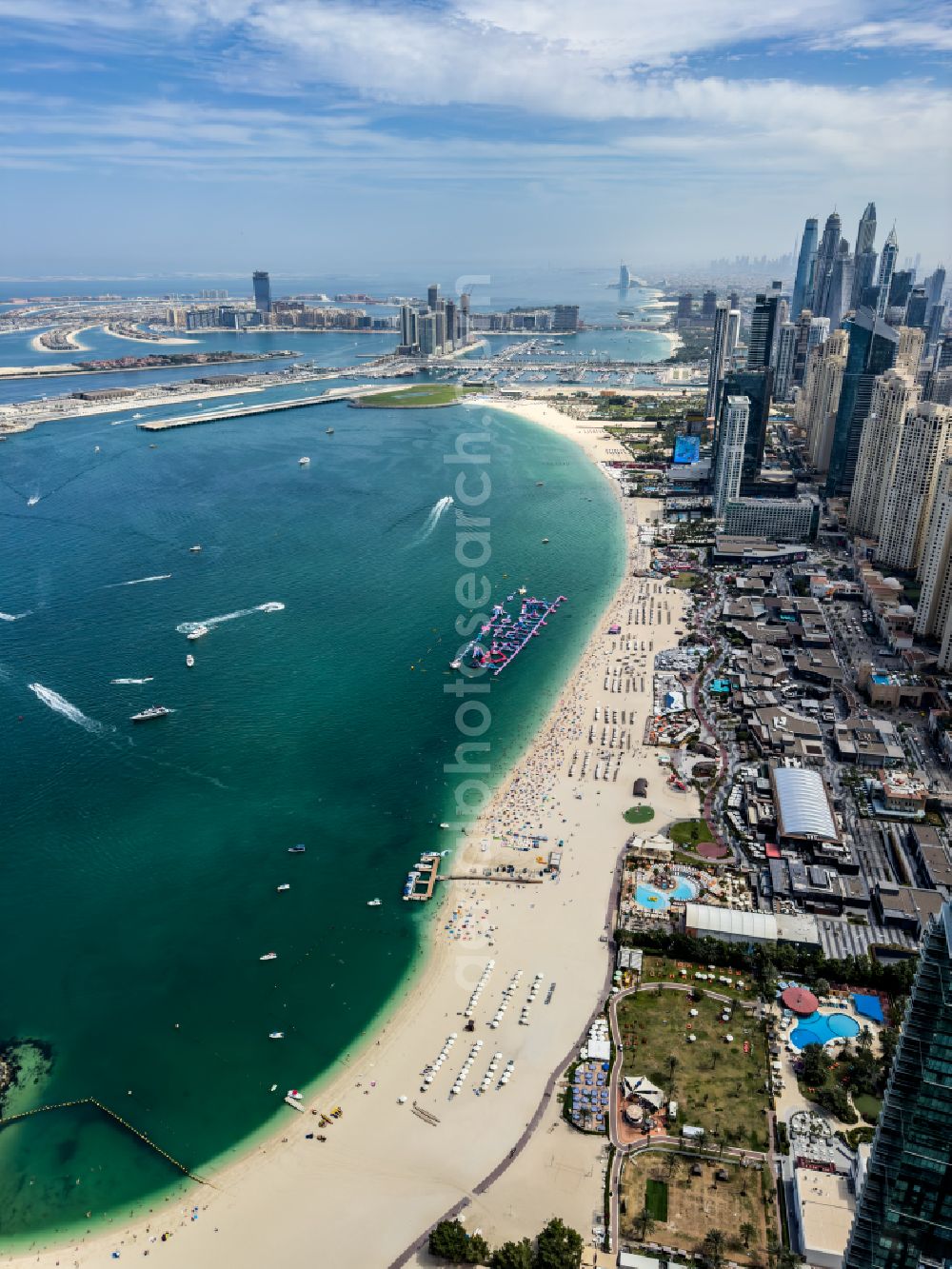Dubai from the bird's eye view: Parasol - rows on the sandy beach in the coastal area Marina Beach on street Al Mamsha Street in Dubai in United Arab Emirates