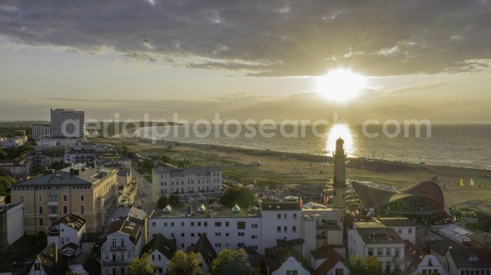 Aerial photograph Rostock - Sunset at restaurants building - ensemble lighthouse - tea pot on the sandy beach of the Baltic Sea in the district Warnemuende in Rostock in the state Mecklenburg-West Pomerania, Germany