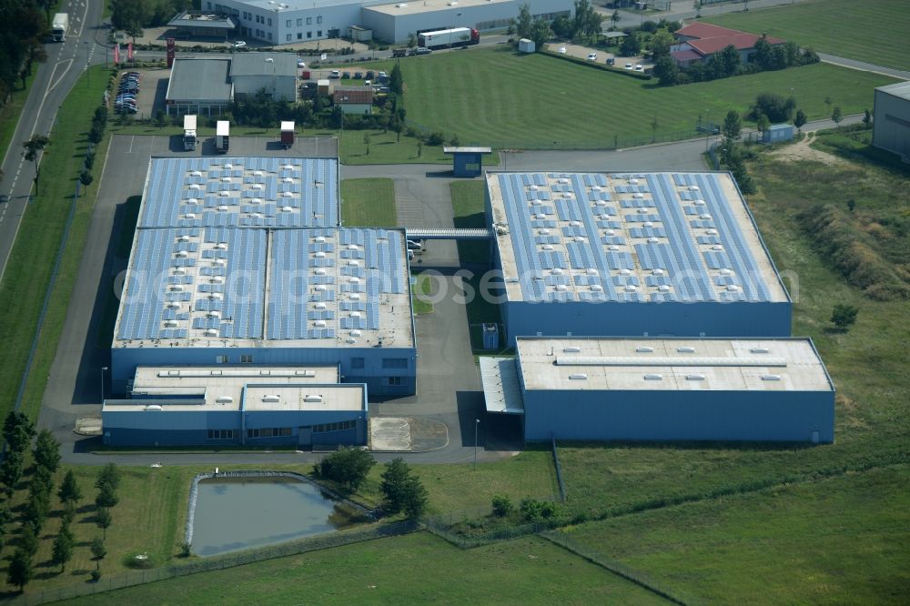 Jessen (Elster) from the bird's eye view: Freight forwarding building of the logistics and transport company Froehlich Trans in the commercial park of Jessen (Elster) in the state of Saxony-Anhalt. The two blue halls are locate adjacent to federal highway 187