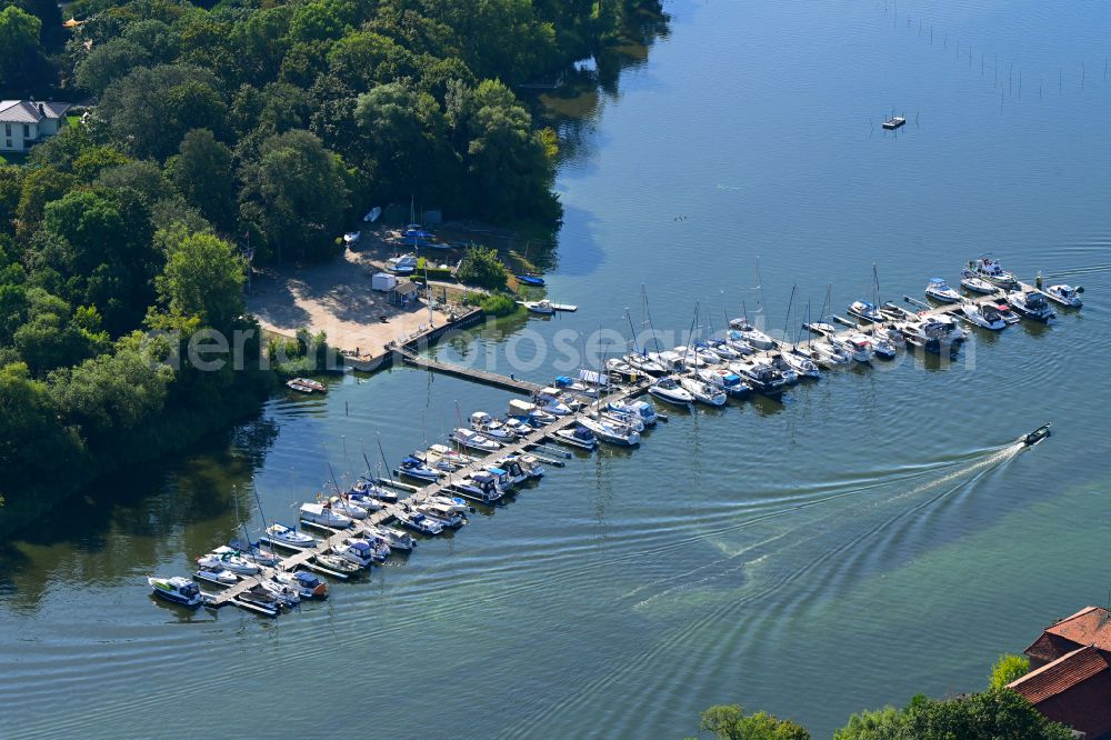 Plaue from above - Pleasure boat and sailing boat landing stage and boat moorings in the harbor on the shore of the Plauer See in Plaue in the state Brandenburg, Germany