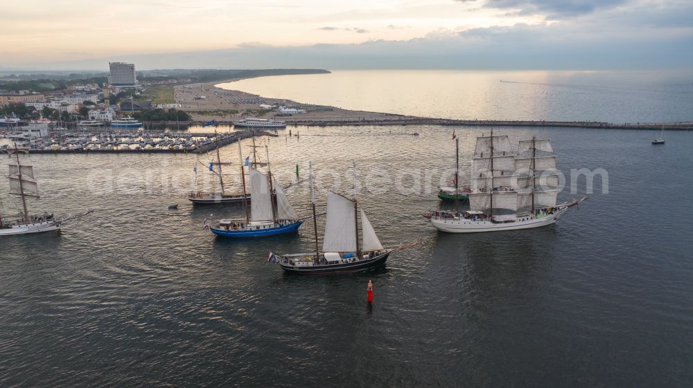 Rostock from above - Pleasure boat sailing ships with white sails traveling to the Hansesail on the Warnow in the Warnemuende district in Rostock on the Baltic Sea coast in the state Mecklenburg-Western Pomerania, Germany