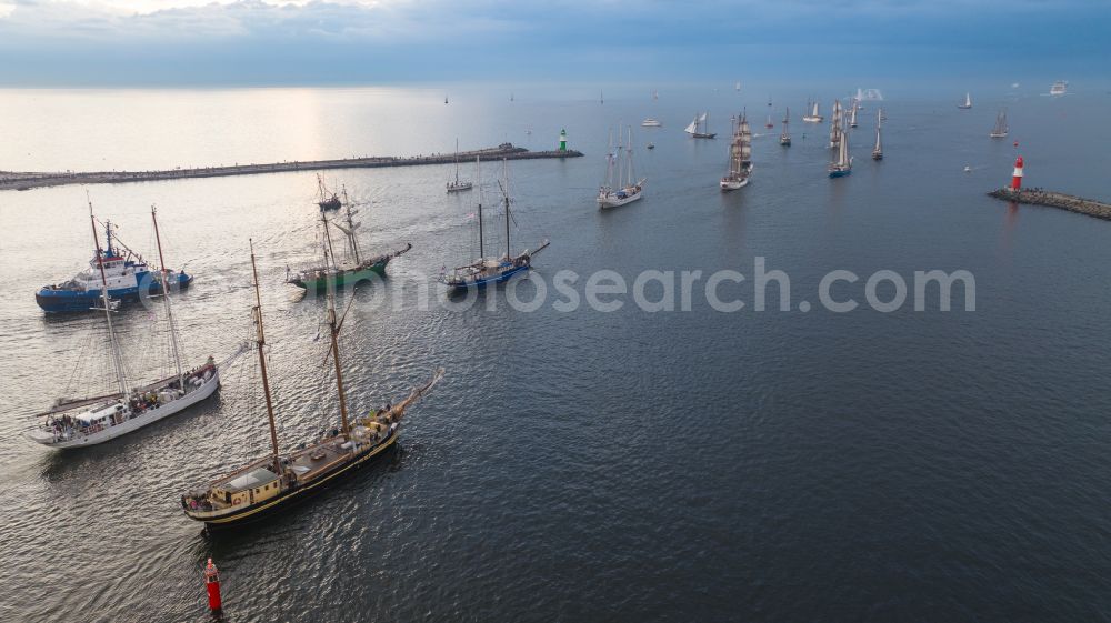 Rostock from the bird's eye view: Pleasure boat sailing ships with white sails traveling to the Hansesail on the Warnow in the Warnemuende district in Rostock on the Baltic Sea coast in the state Mecklenburg-Western Pomerania, Germany