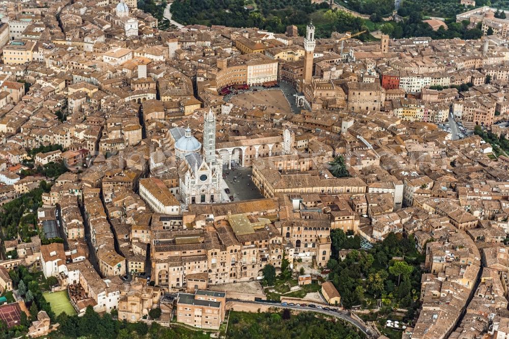 Aerial image Siena - City view of Siena in the homonymous province in Italy. Between various buildings, the Gothic cathedral and the Palazzo Publico is the Torre del Mangia