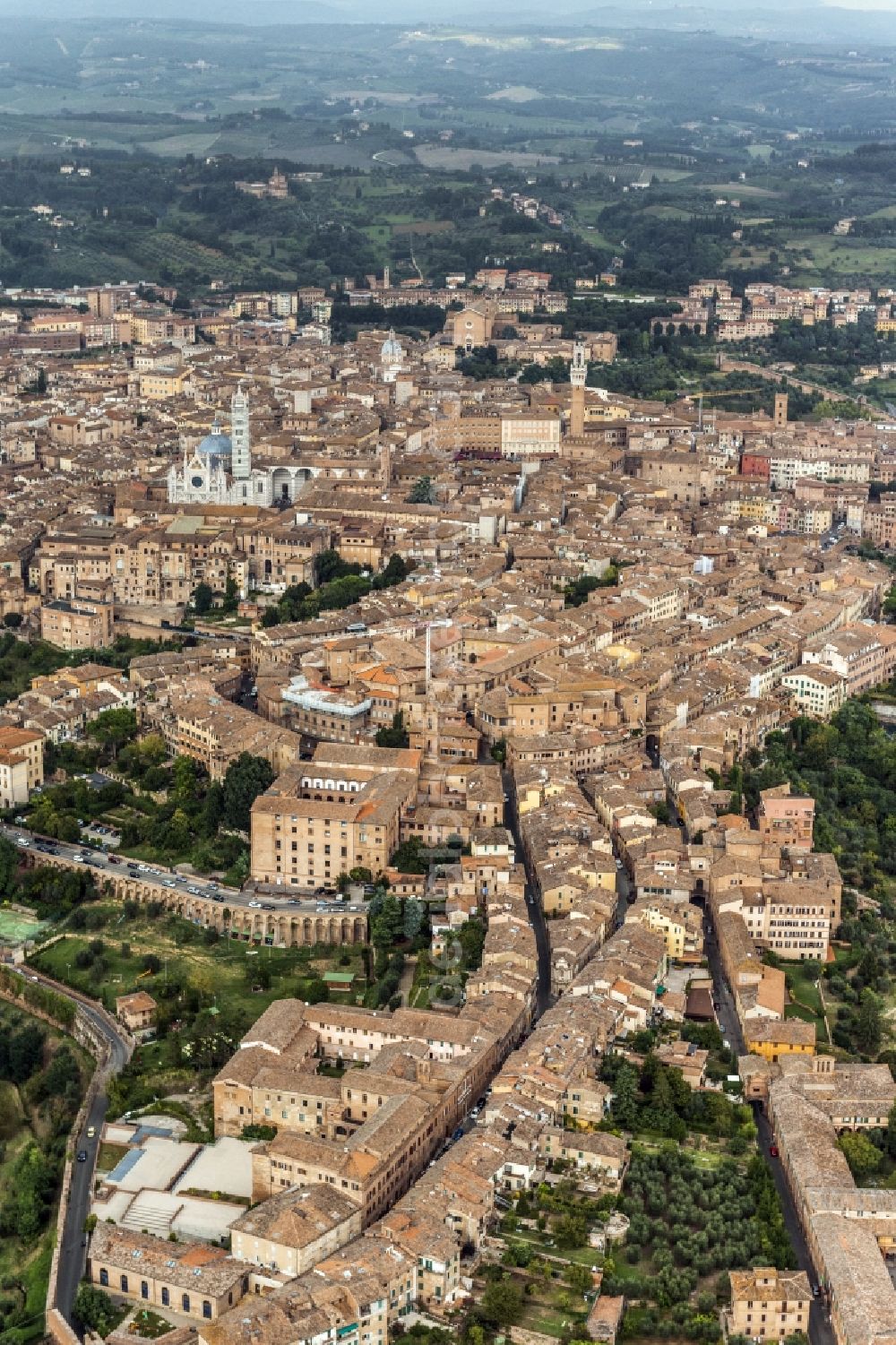 Aerial photograph Siena - City view of Siena in the homonymous province in Italy. Between various buildings, the Gothic cathedral and the Palazzo Publico is the Torre del Mangia