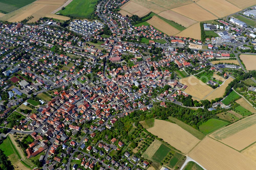 Estenfeld from the bird's eye view: Urban area with outskirts and inner city area on the edge of agricultural fields and arable land in Estenfeld in the state Bavaria, Germany