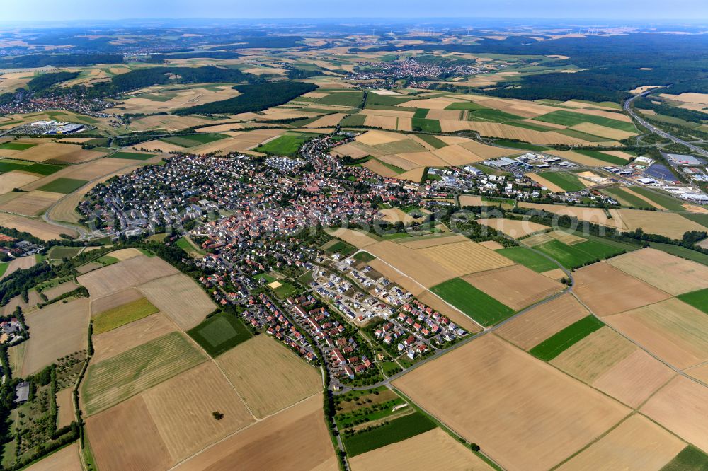 Aerial image Estenfeld - Urban area with outskirts and inner city area on the edge of agricultural fields and arable land in Estenfeld in the state Bavaria, Germany