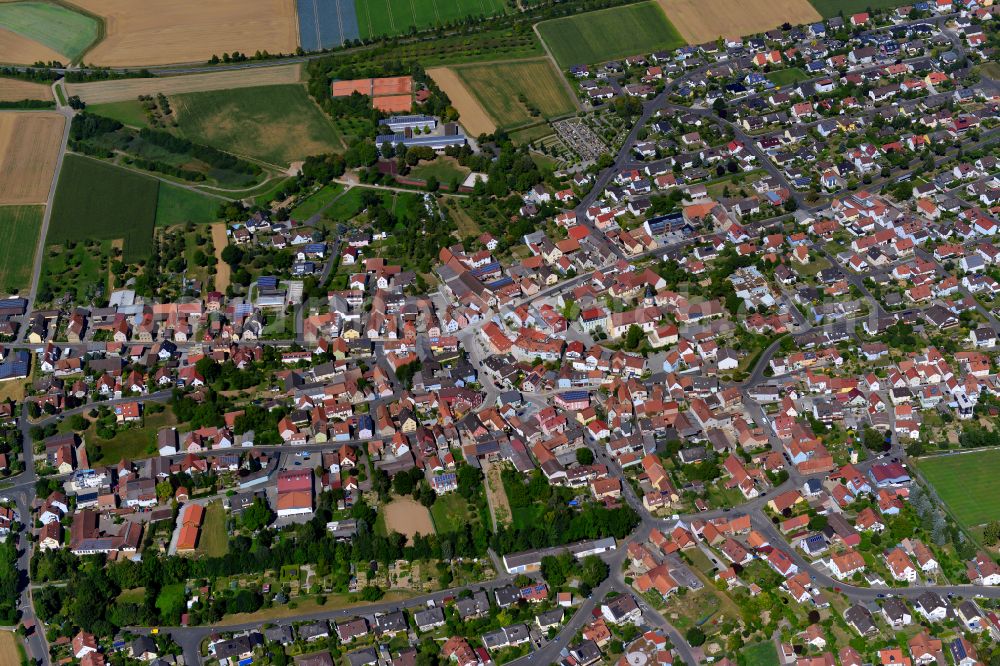 Aerial photograph Kürnach - Urban area with outskirts and inner city area on the edge of agricultural fields and arable land in Kürnach in the state Bavaria, Germany