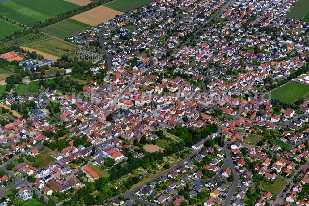 Aerial image Kürnach - Urban area with outskirts and inner city area on the edge of agricultural fields and arable land in Kürnach in the state Bavaria, Germany