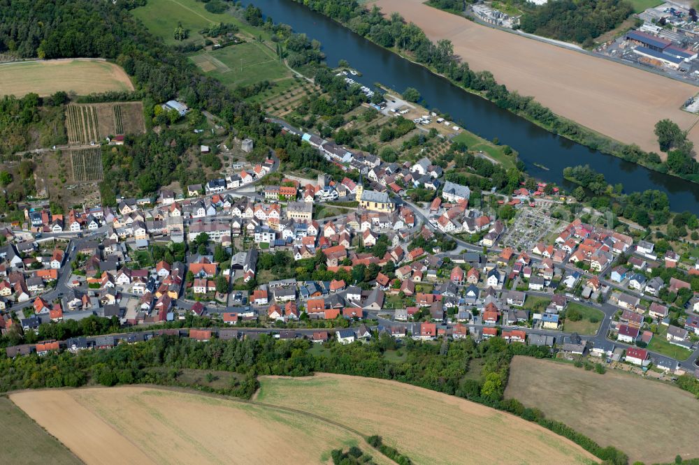 Aerial image Laudenbach - Urban area with outskirts and inner city area on the edge of agricultural fields and arable land in Laudenbach in the state Bavaria, Germany