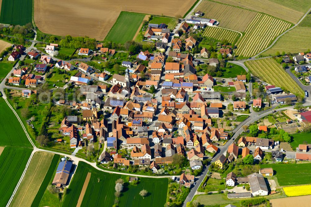 Neuses a.Berg from the bird's eye view: Urban area with outskirts and inner city area on the edge of agricultural fields and arable land in Neuses a.Berg in the state Bavaria, Germany