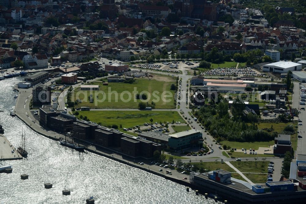 Aerial image Wismar - View of the Old Harbour Alter Holzhafen in the North of the historic town centre of Wismar in the state of Mecklenburg - Western Pomerania. Parks, lawns, residential and commercial buildings are located on the historic site today