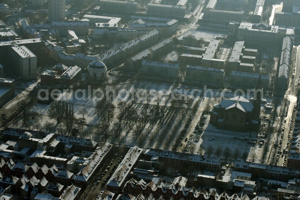 Potsdam from above - View of the snow-covered surrounding area of Bassinplatz Square in the town centre of Potsdam in the state of Brandenburg. Saint Peter and Paul church is located on the Western end of the square, surrounded by historic buildings