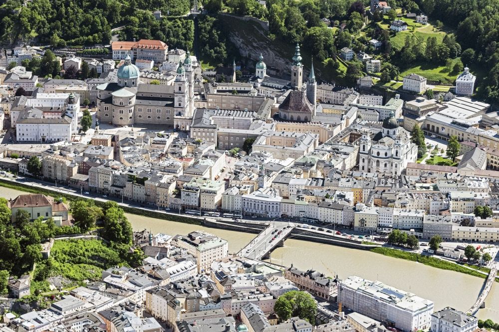 Salzburg from above - City center in the downtown area on the banks of river course of Salzach in Salzburg in Austria