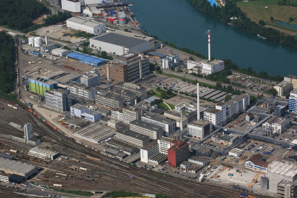 Muttenz from the bird's eye view: Buildings and production halls on the premises of the industrial park Infrapark Baselland AG in Muttenz in the canton Basel-Landschaft, Switzerland