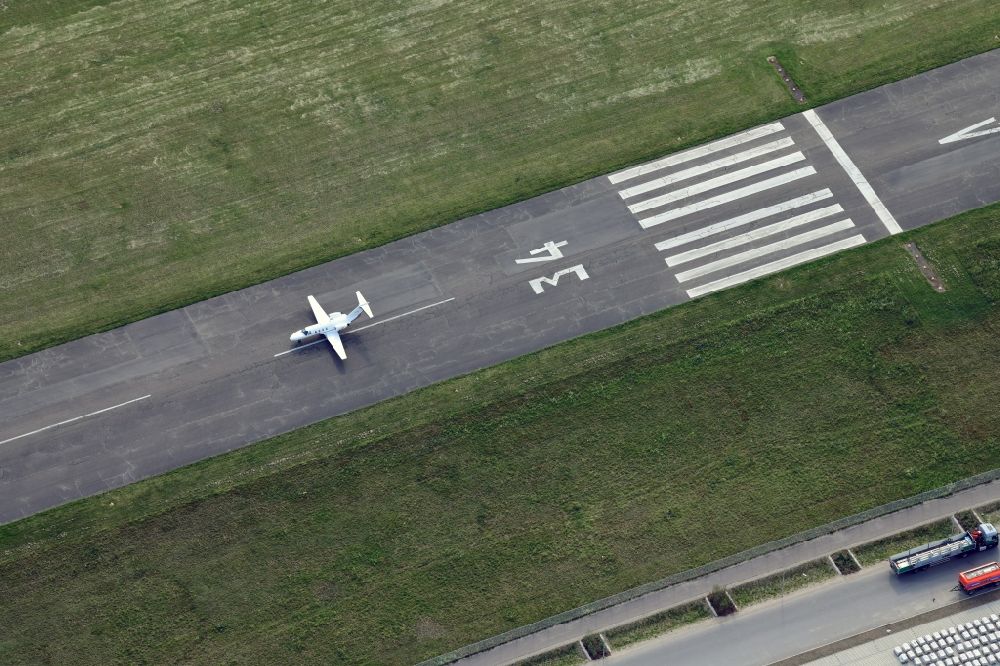 Aerial photograph Freiburg im Breisgau - Runway 34 and departing business jet at the airport EDTF in Freiburg im Breisgau in the state Baden-Wurttemberg, Germany