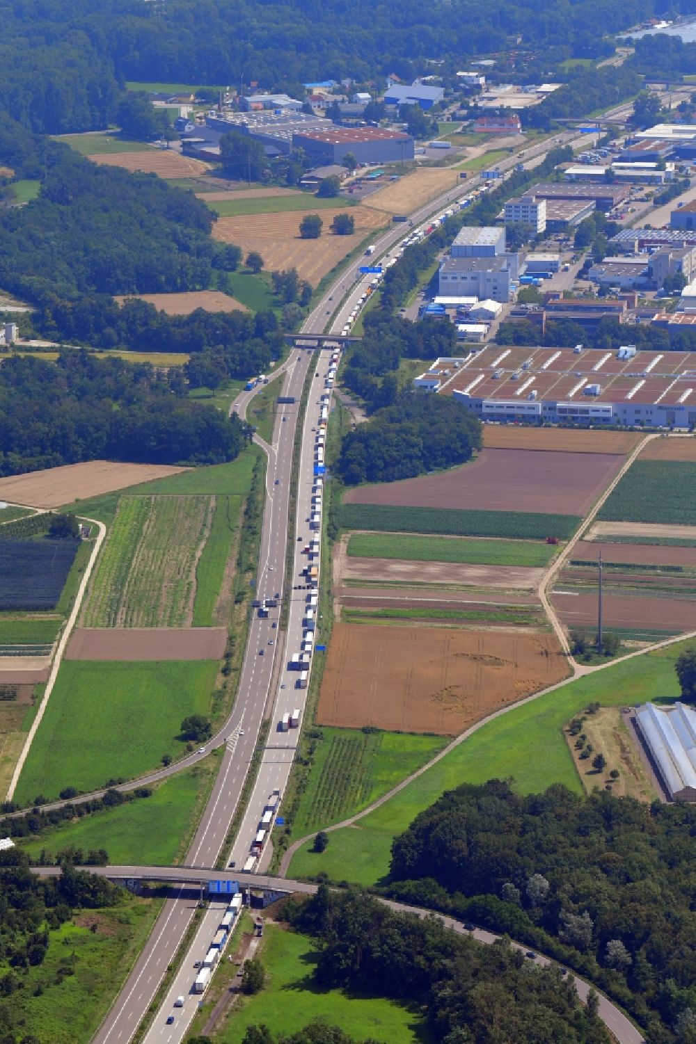 Weil am Rhein from above - Daily truck traffic jam at the Swiss border on highway triangle of the federal motorway A 5 / A98 in the district Maerkt in Weil am Rhein in the state Baden-Wurttemberg, Germany