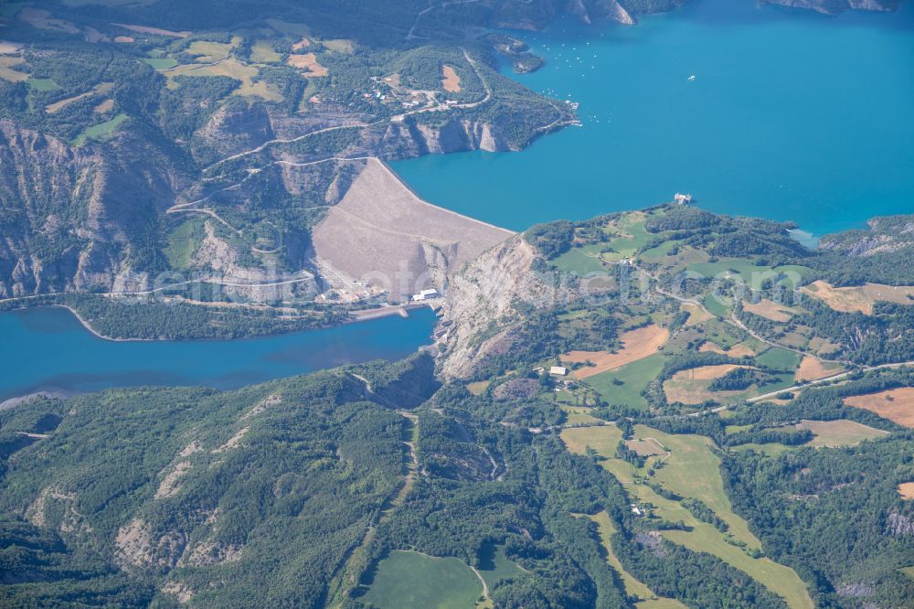 Aerial image Ubaye-Serre-Poncon - Dam wall at the reservoir Lac de Serre-Poncon in Ubaye-Serre-Poncon in Provence-Alpes-Cote d'Azur, France